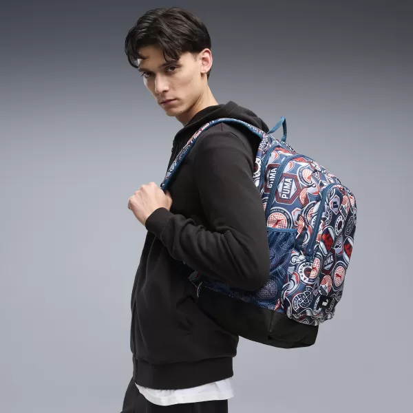  Раница PUMA ACADEMY AOP BACKPACK 09115027 MIDNIGHT PETROL/FOR ALL TIME RED/RUNNING BADGES AOP 